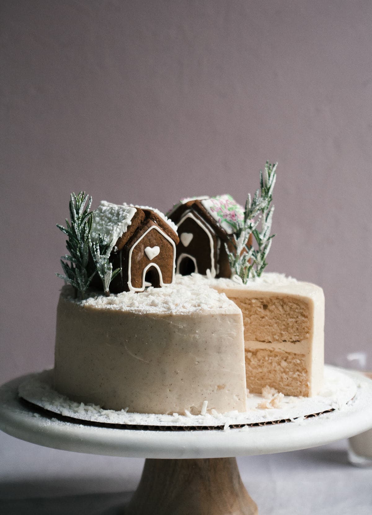 Side view of a decorated cake with a slice missing.