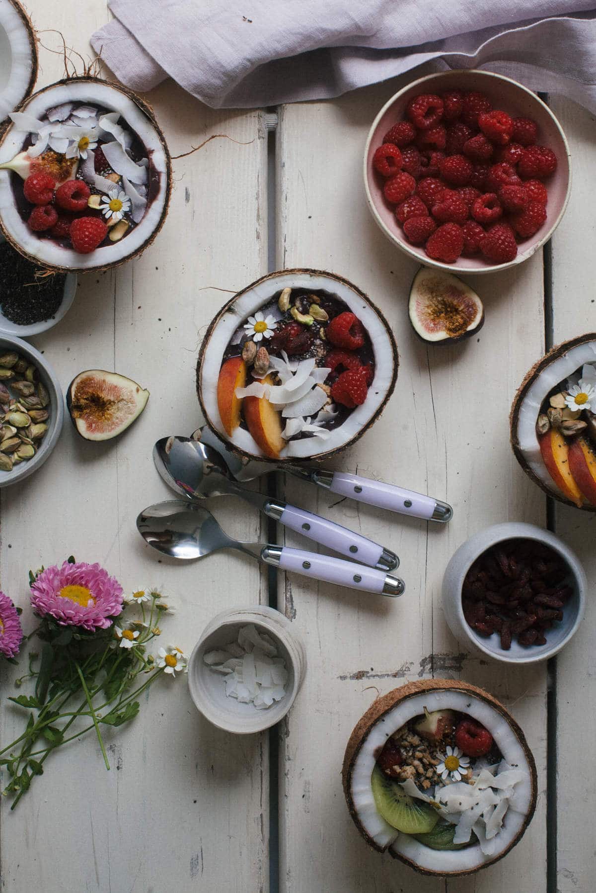 Acaí Bowls in coconuts with toppings.