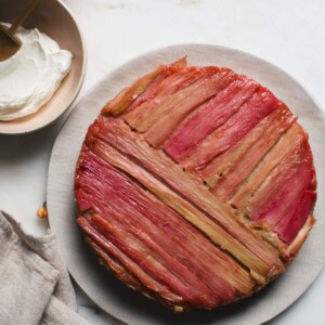 Close up image of a rhubarb upside down cake on a plate.