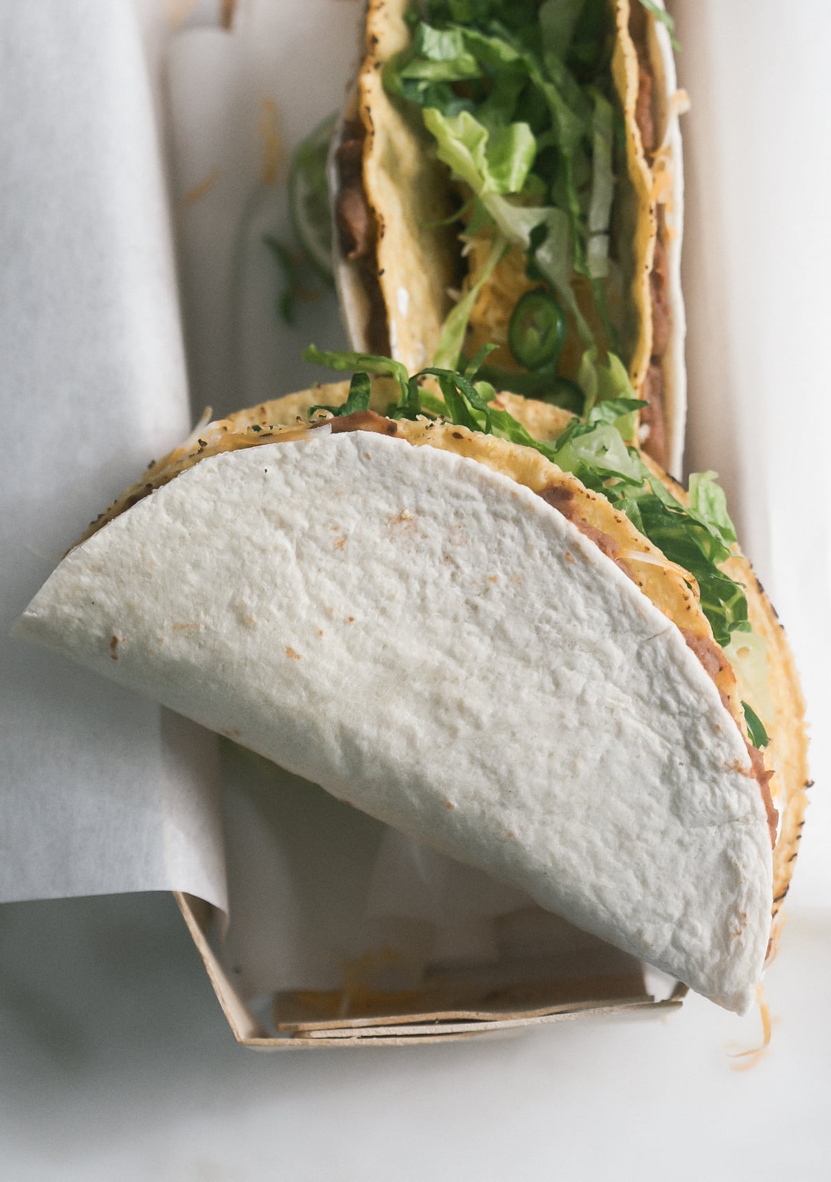 Overhead image of a side of a taco on a box.