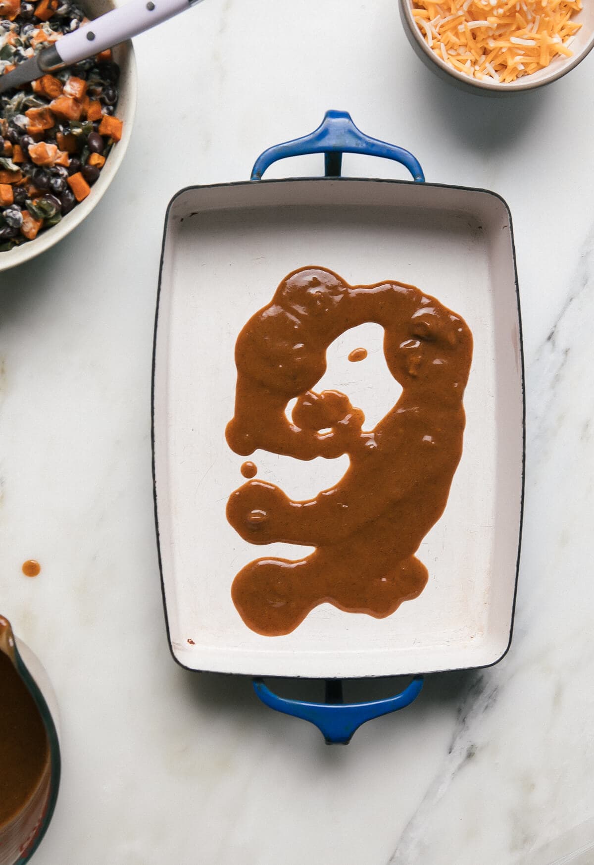 Enchilada red sauce in a baking dish.