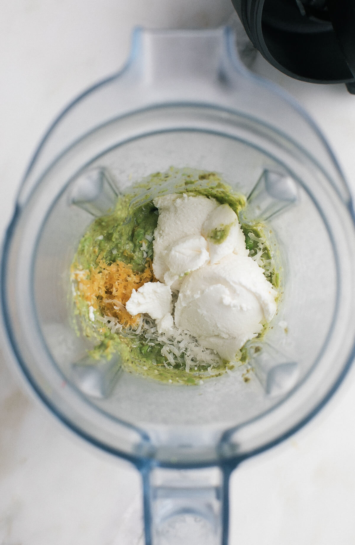 Pesto ingredients in a blender.