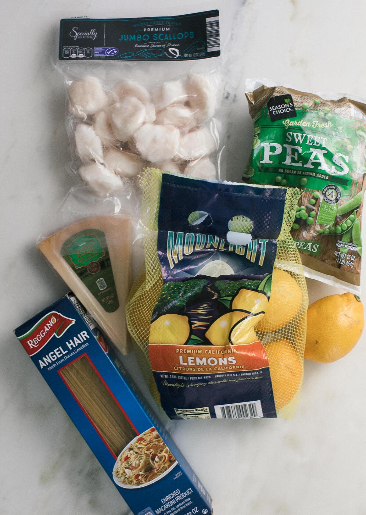 Ingredients for pesto pasta on a counter.