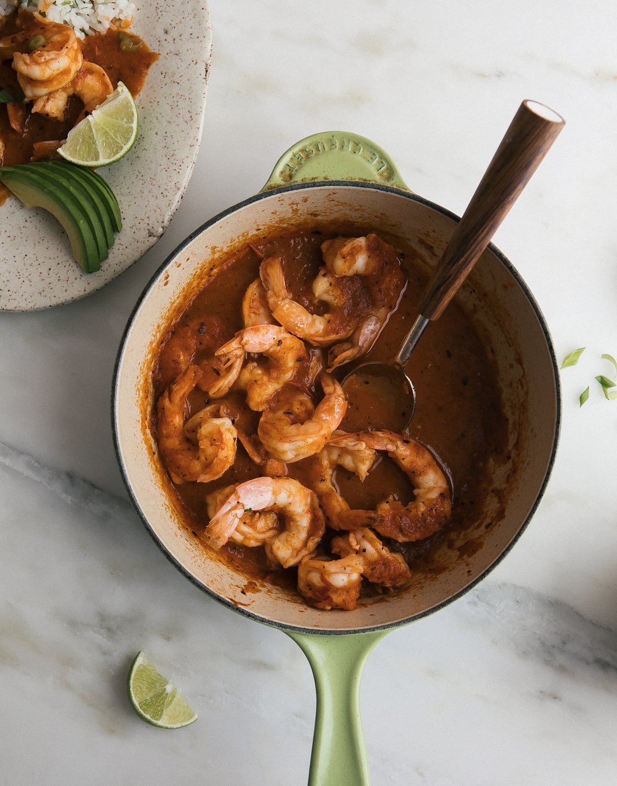 Cooked shrimp in red sauce inside a skillet. 