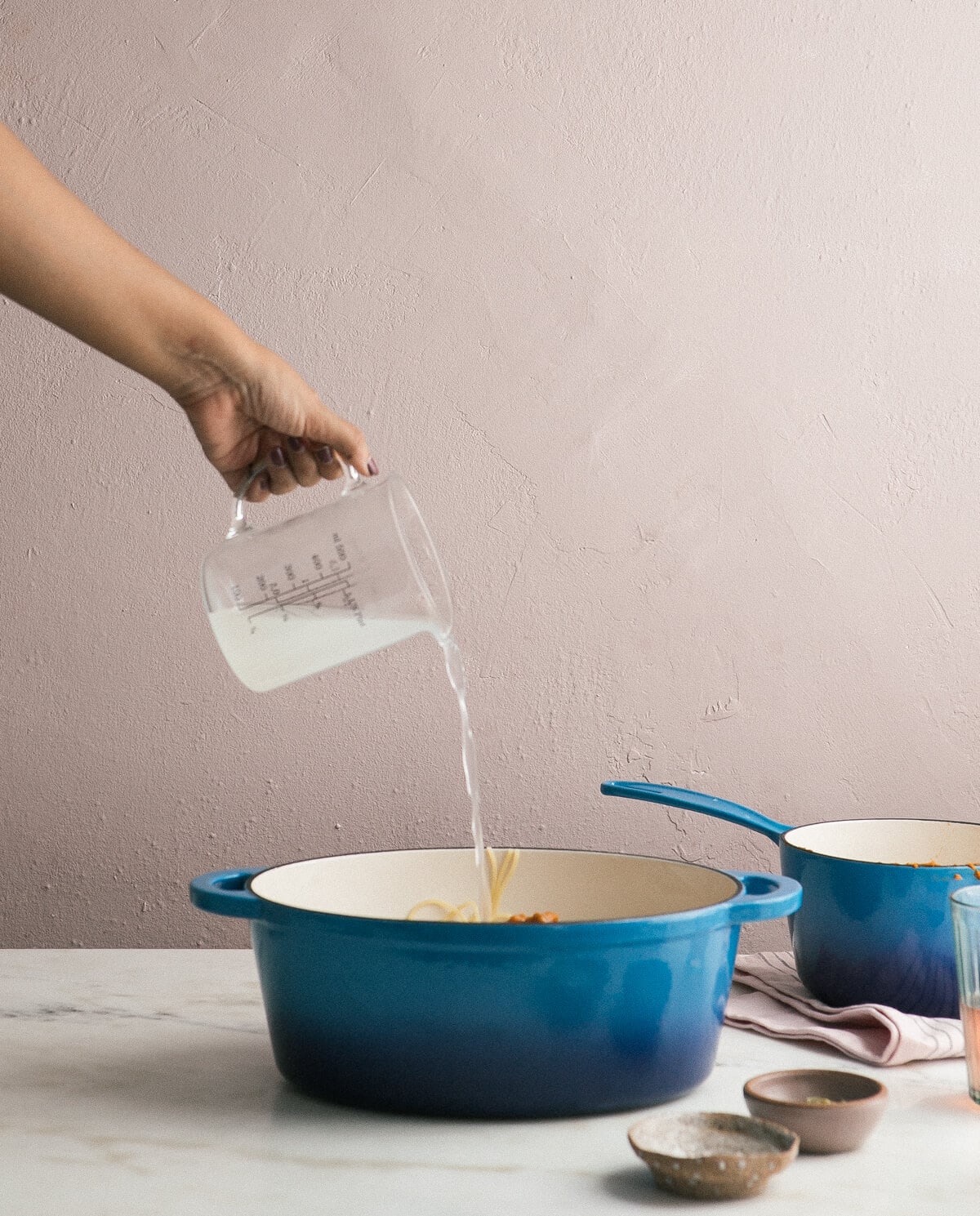 Pasta water being added. 