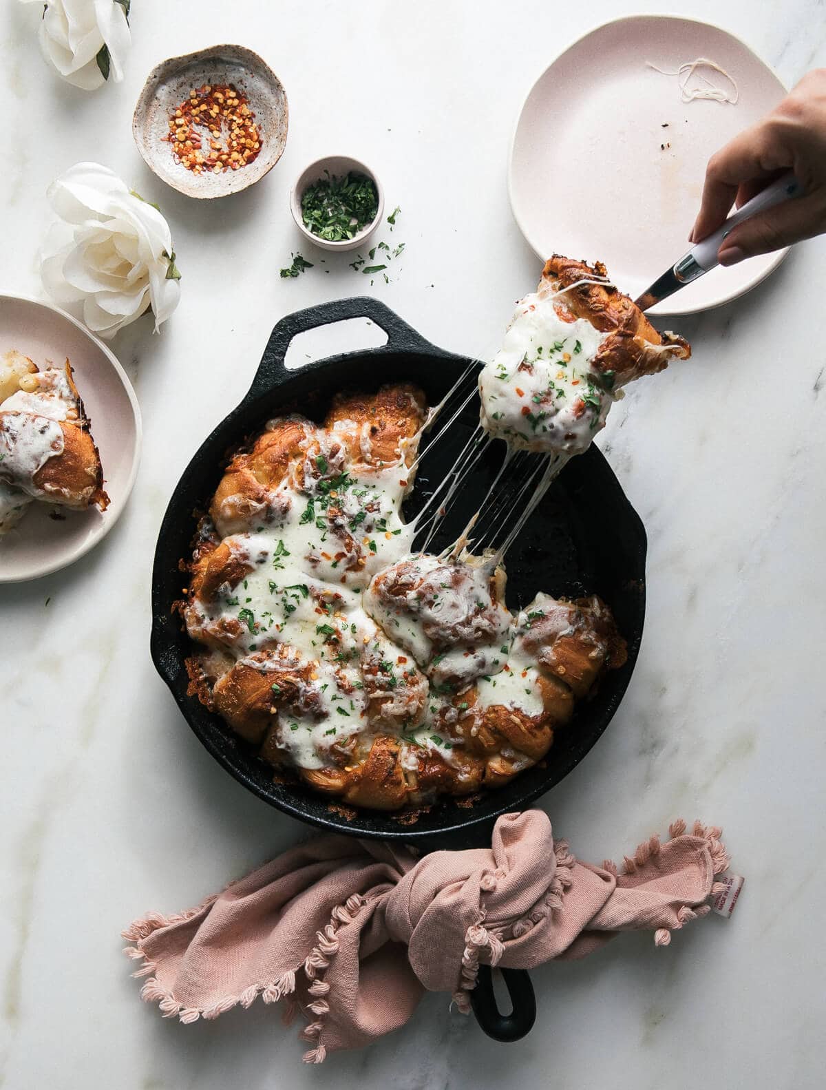 Cheesy Roasted Garlic Knots with one being taken out. 