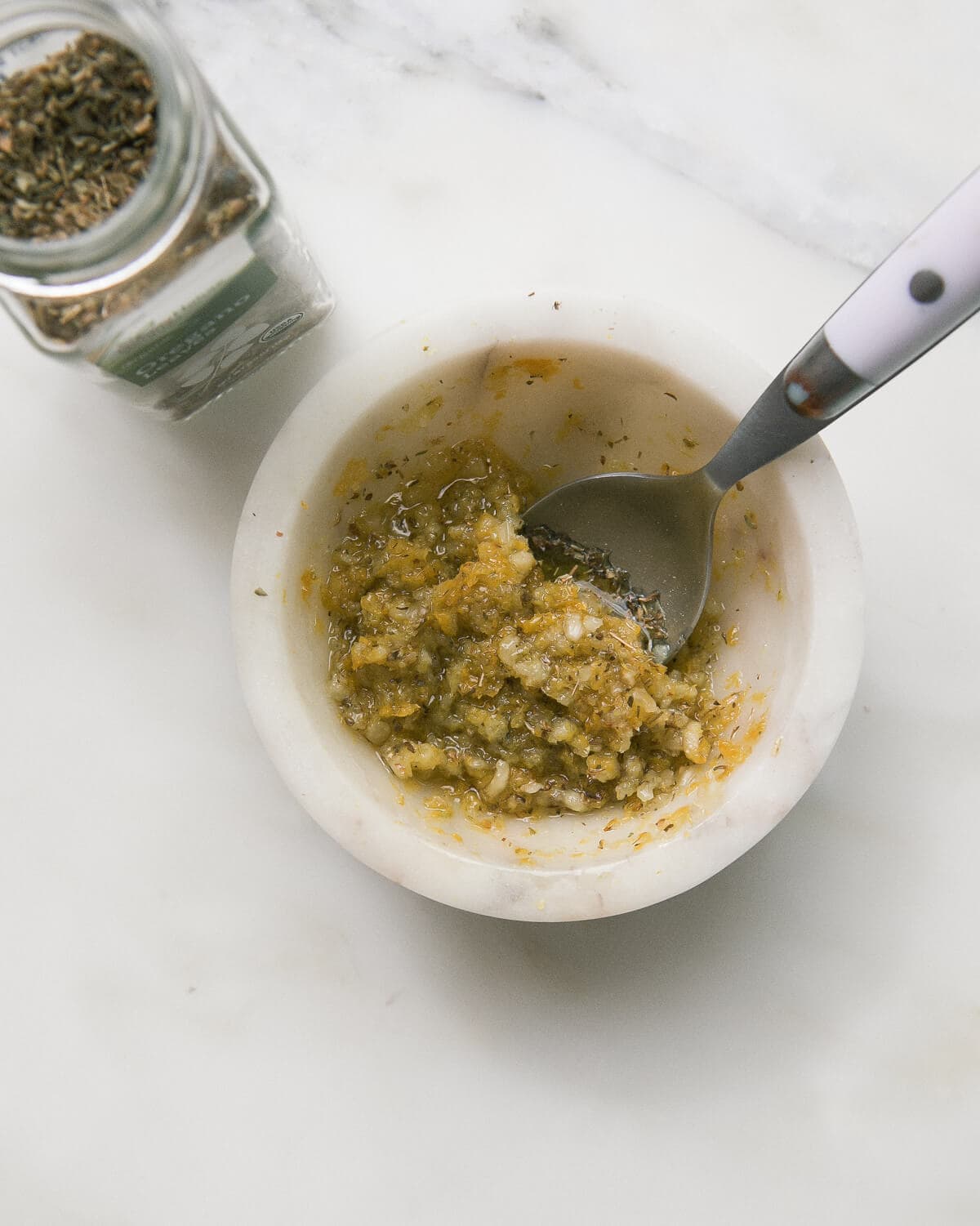 Mojo marinade in a bowl with a spoon.