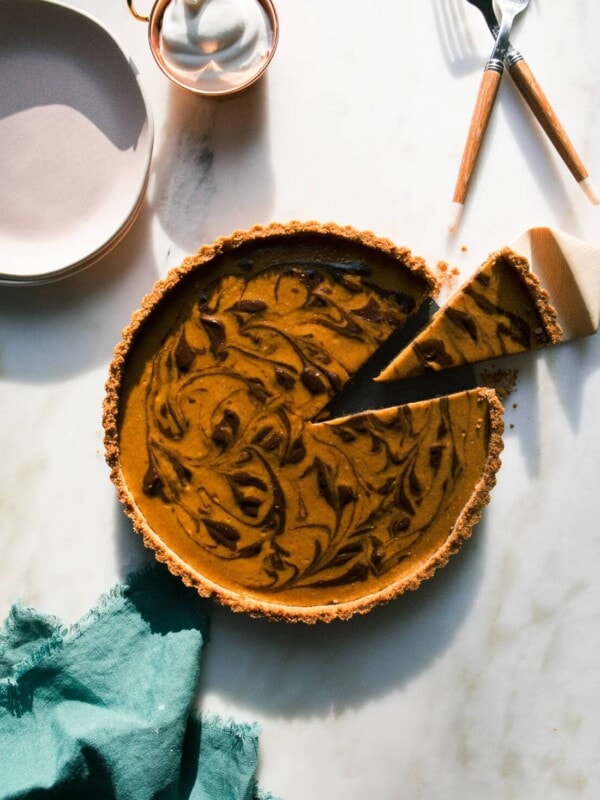 Marbled Chocolate Pumpkin Cheesecake with a slice taken out.