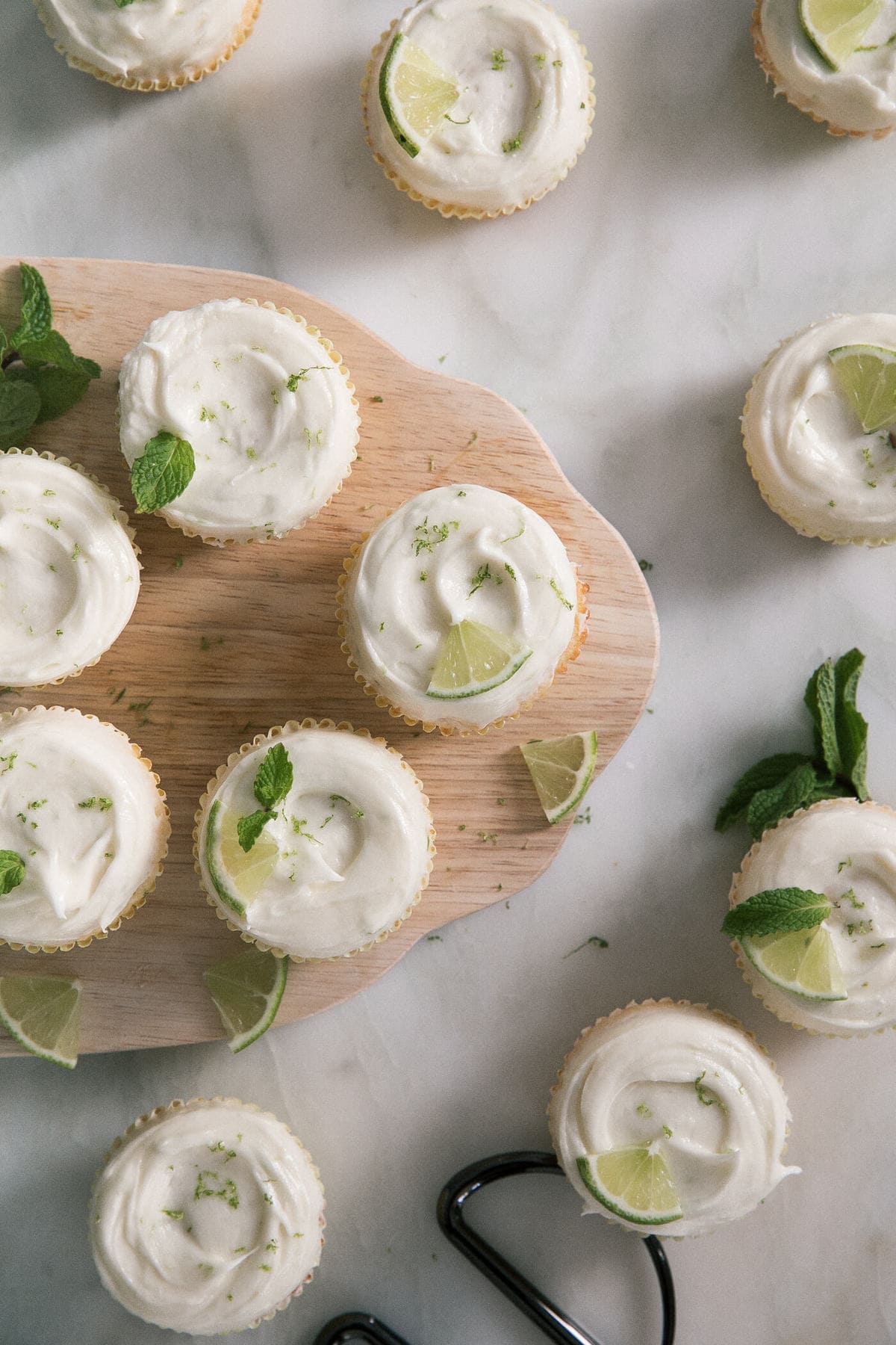 Overhead image of mojito cupcakes on a cutting board.