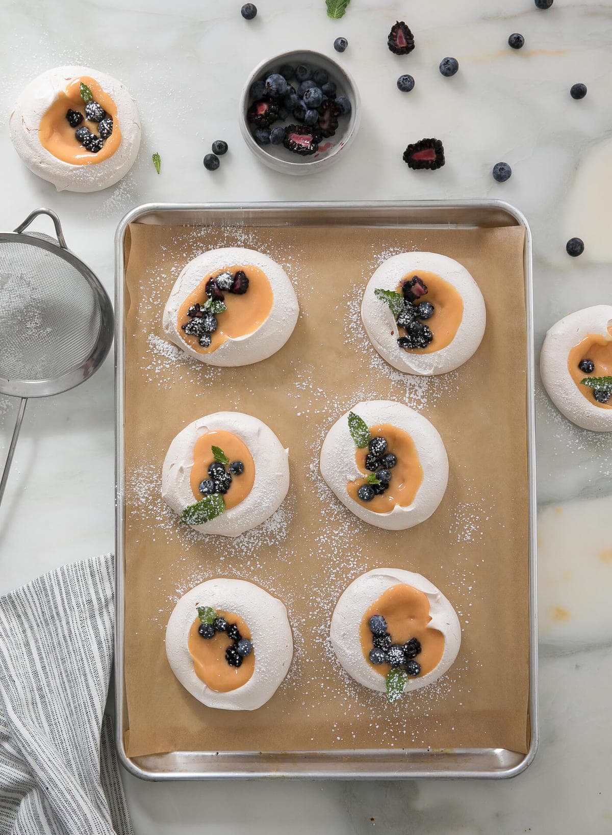 Meringues with Citrus Curd on a baking sheet. 