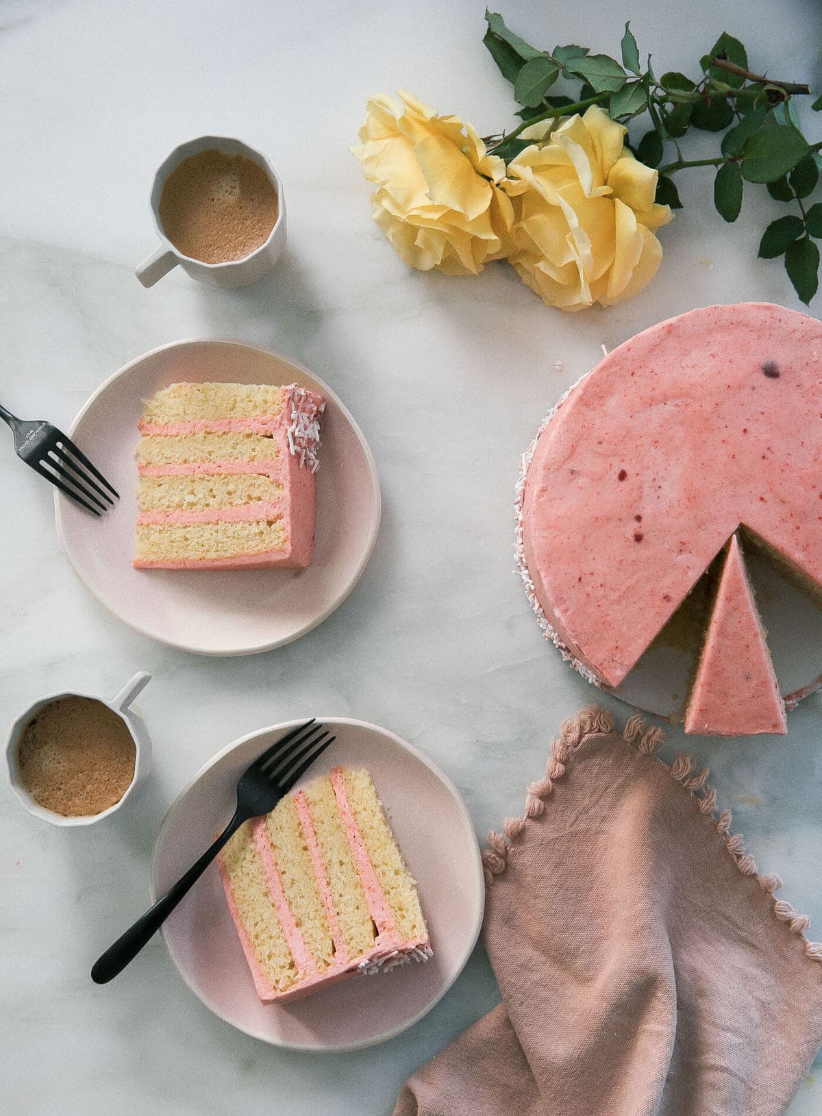 Slices of corn cake with guava frosting on plates.