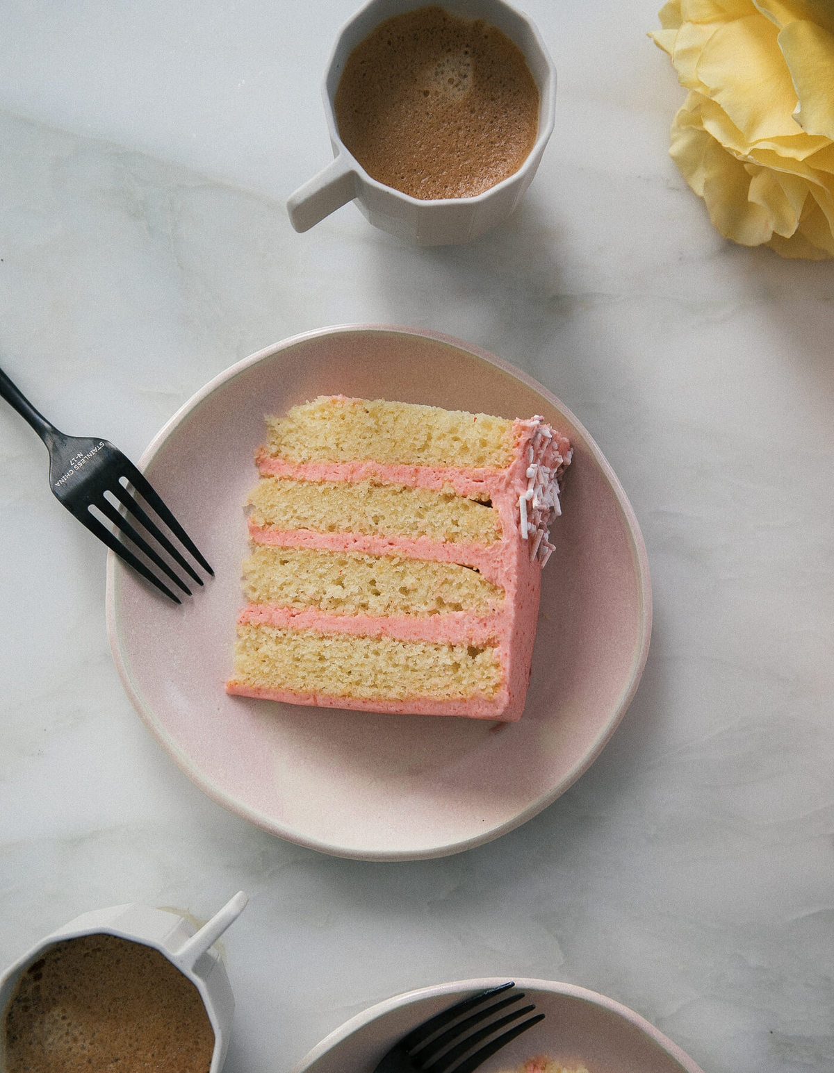 Close up image of corn cake on a plate with guava frosting.