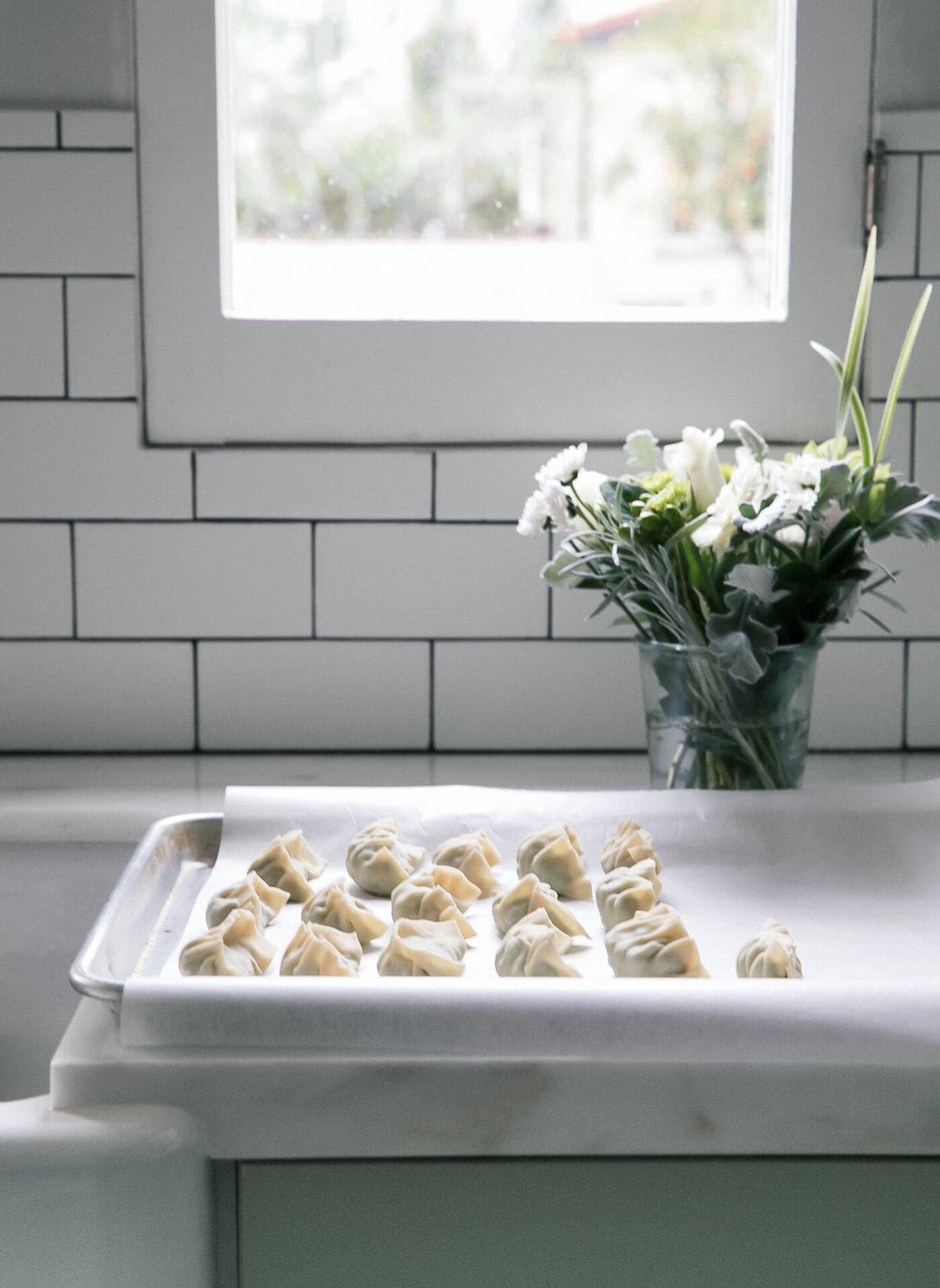 Side view of dumplings on a sheet pan. 