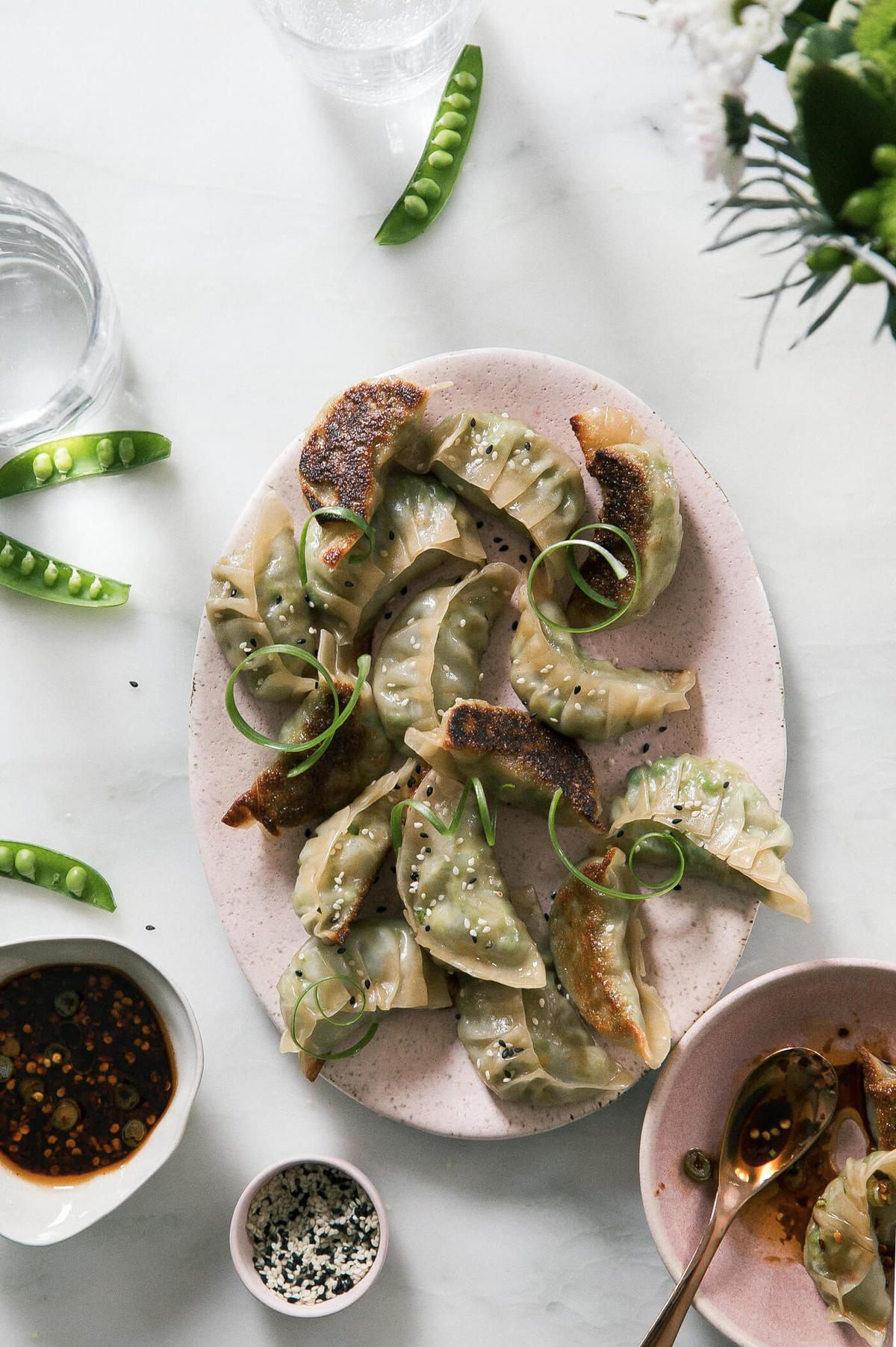 Close up image of vegetarian potstickers on a serving platter. 