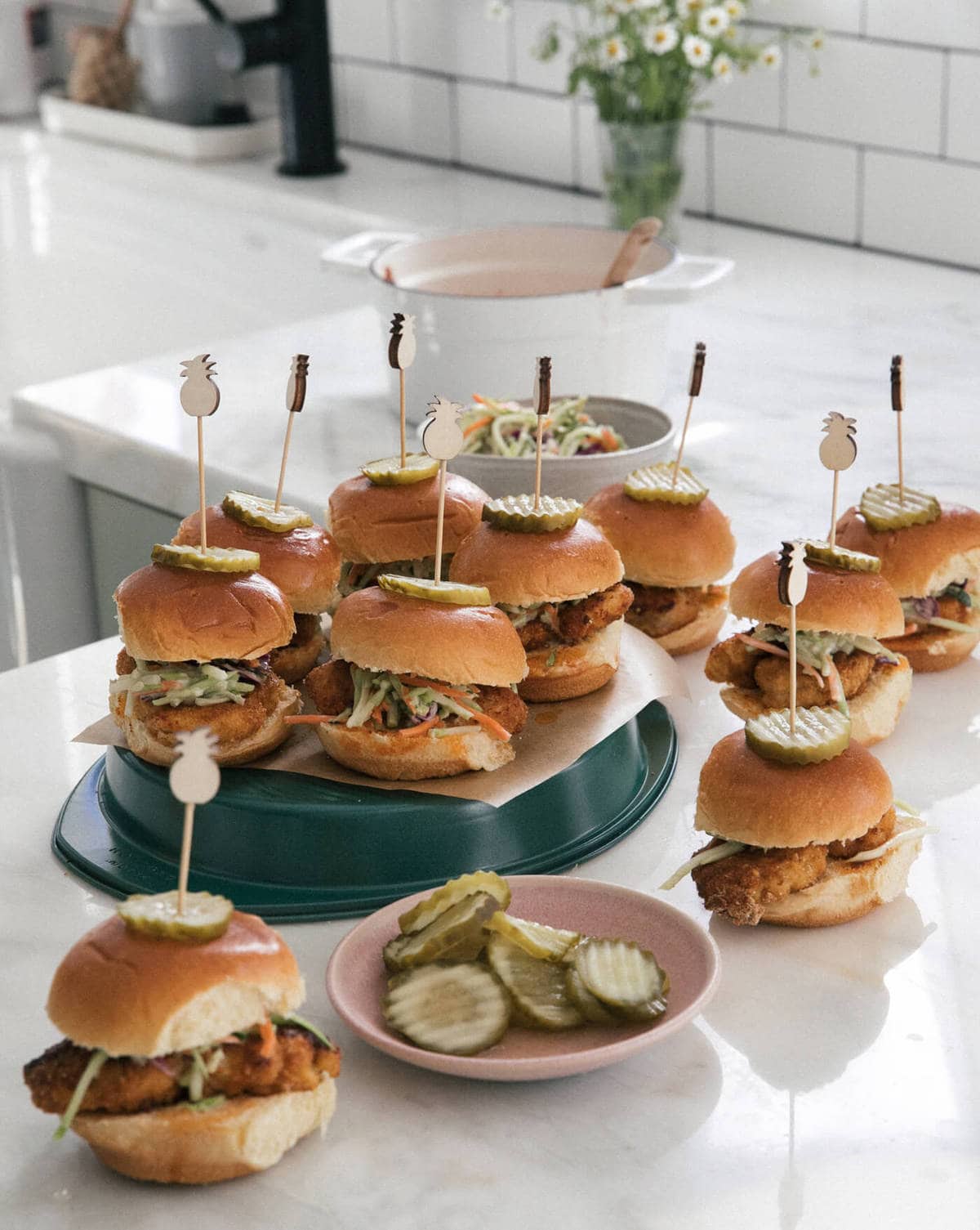 Baked Nashville Hot Chicken Sandwiches with skewers in the tops of the sandwiches. 