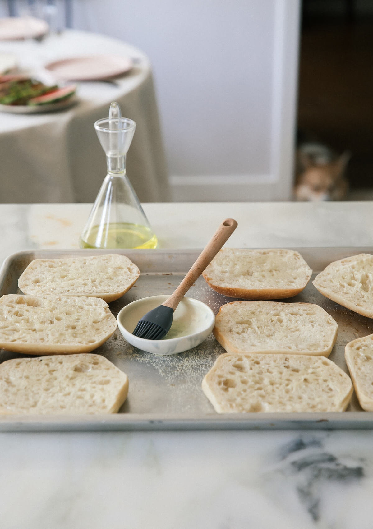 Drizzling olive oil on bread. 