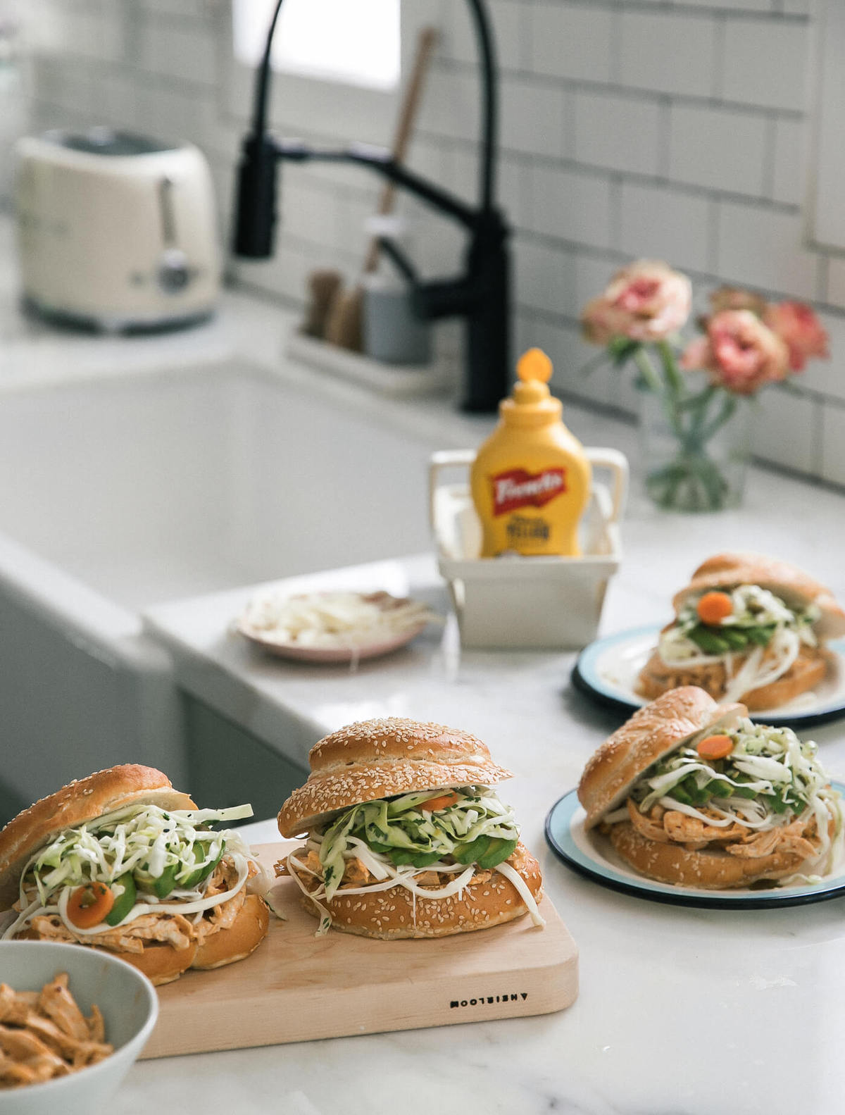 Cemitas Poblanas on cutting board on plates. 