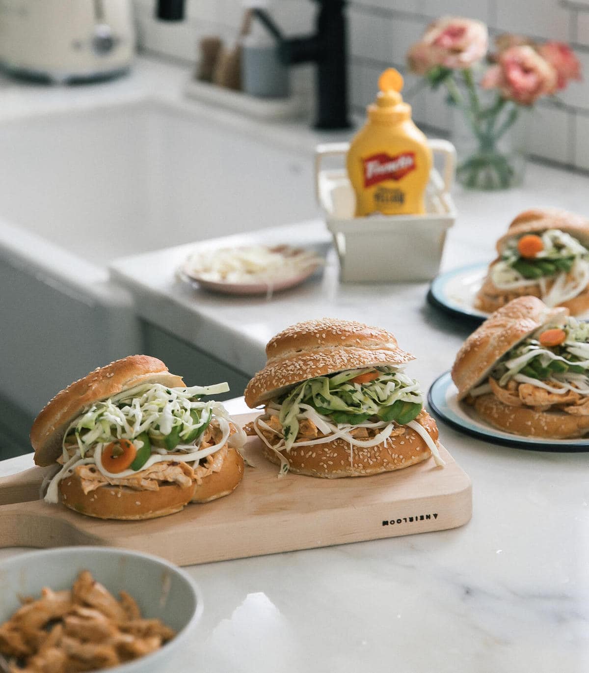 Cemitas Poblanas on cutting board on plates. 