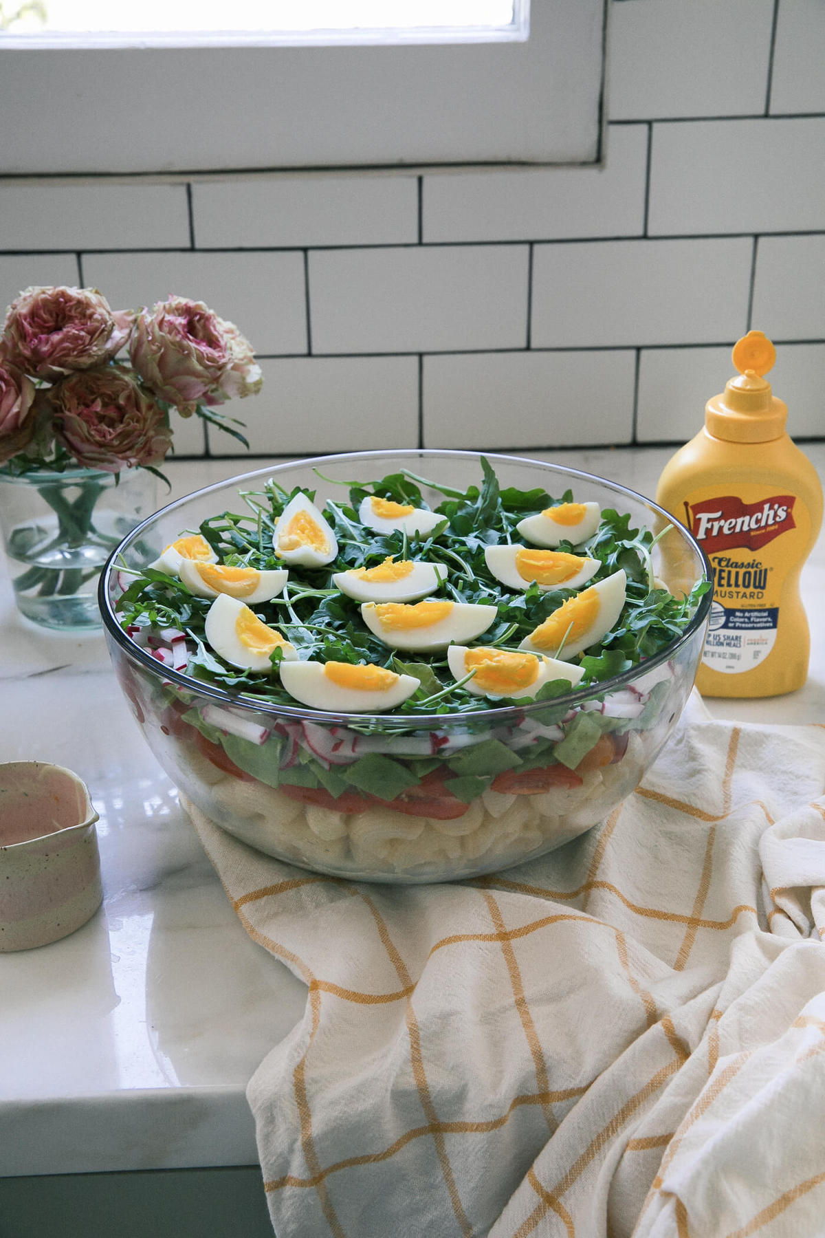 Seven Layer Pasta Salad in serving bowl on counter. 