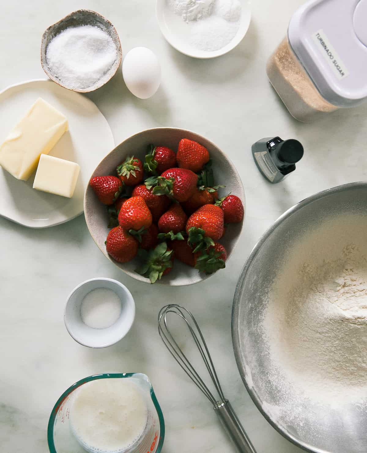 Ingredients for this big strawberry shortcake. All in bowls and measuring cups. 
