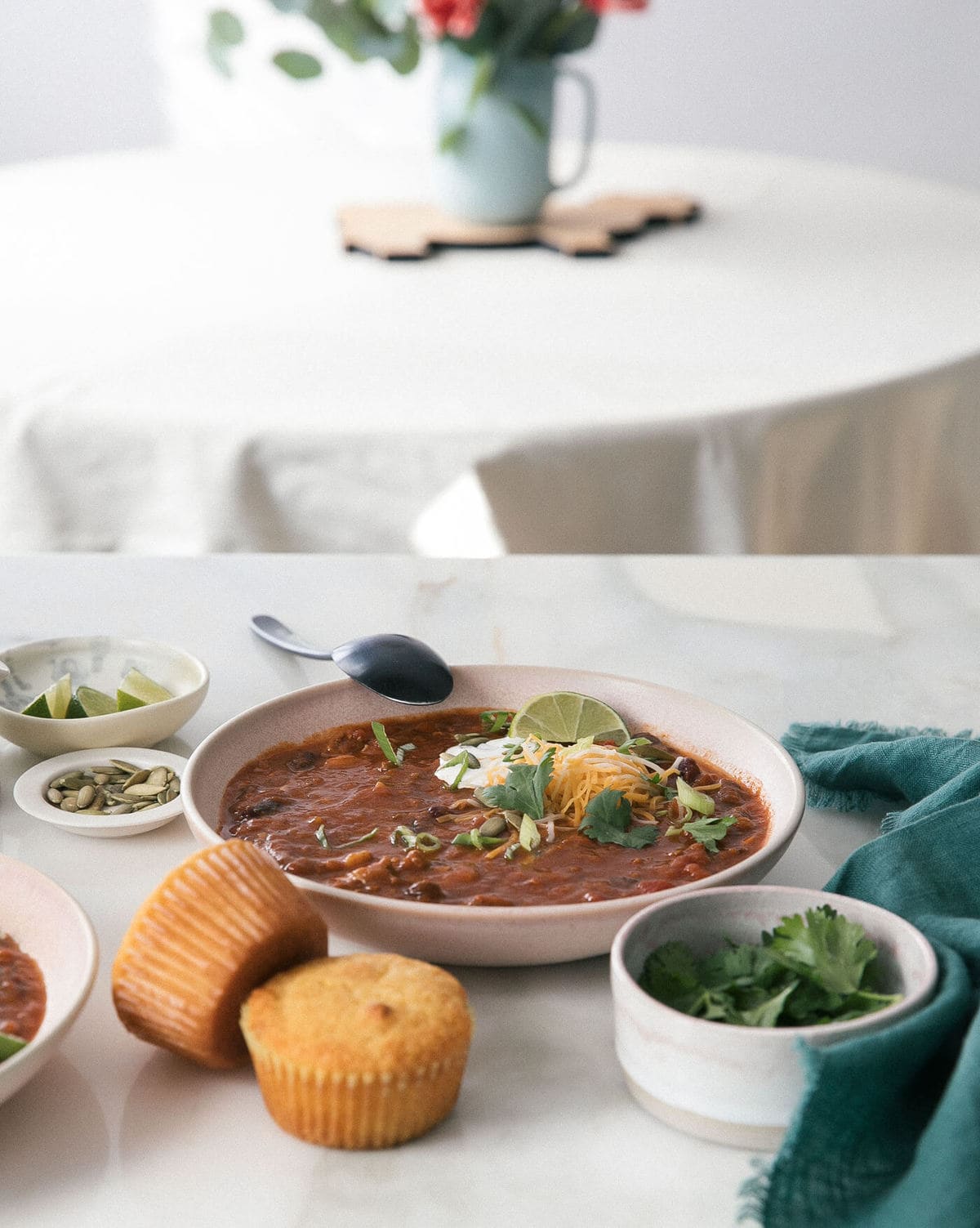 Pumpkin chili in a bowl with garnishes on top. 