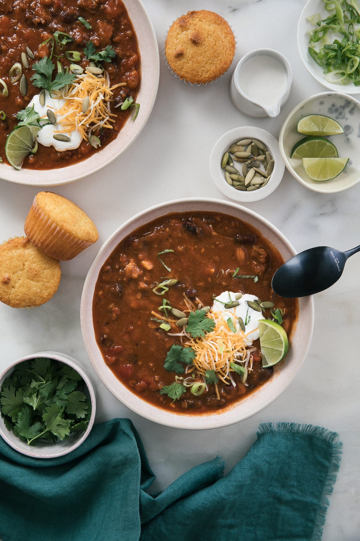 Pumpkin chili in a bowl with garnishes on top. 