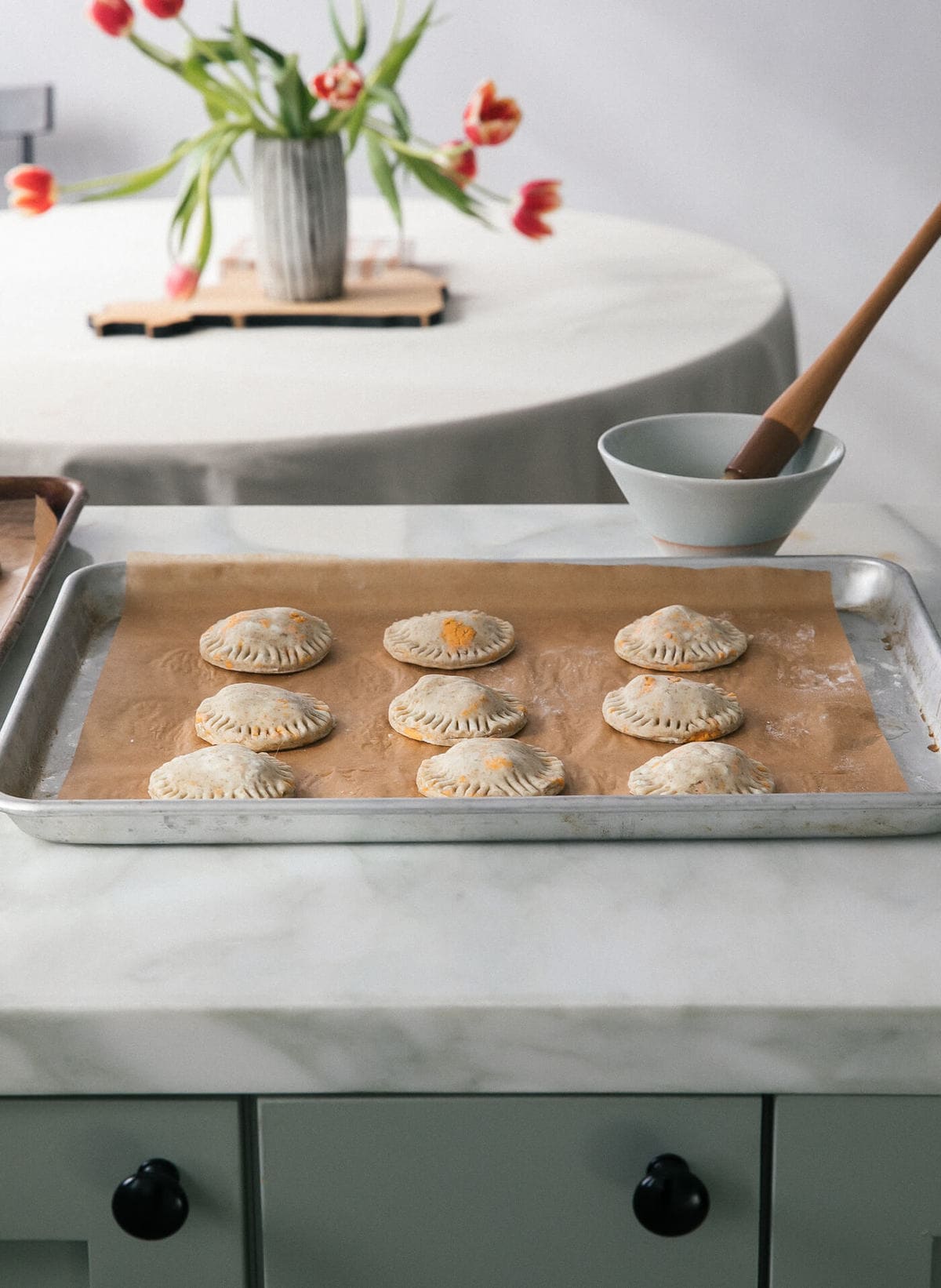 Mini pies on a sheet pan.
