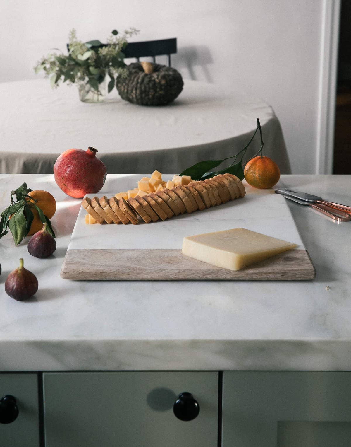 Crackers being arranged on cutting board. 