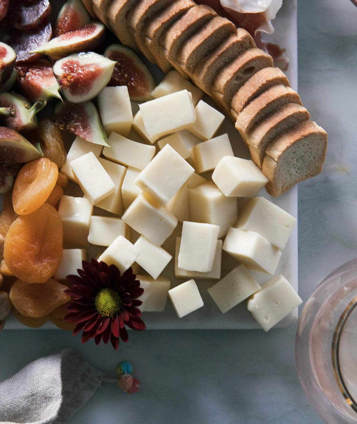 Cheese cubed on a board. 