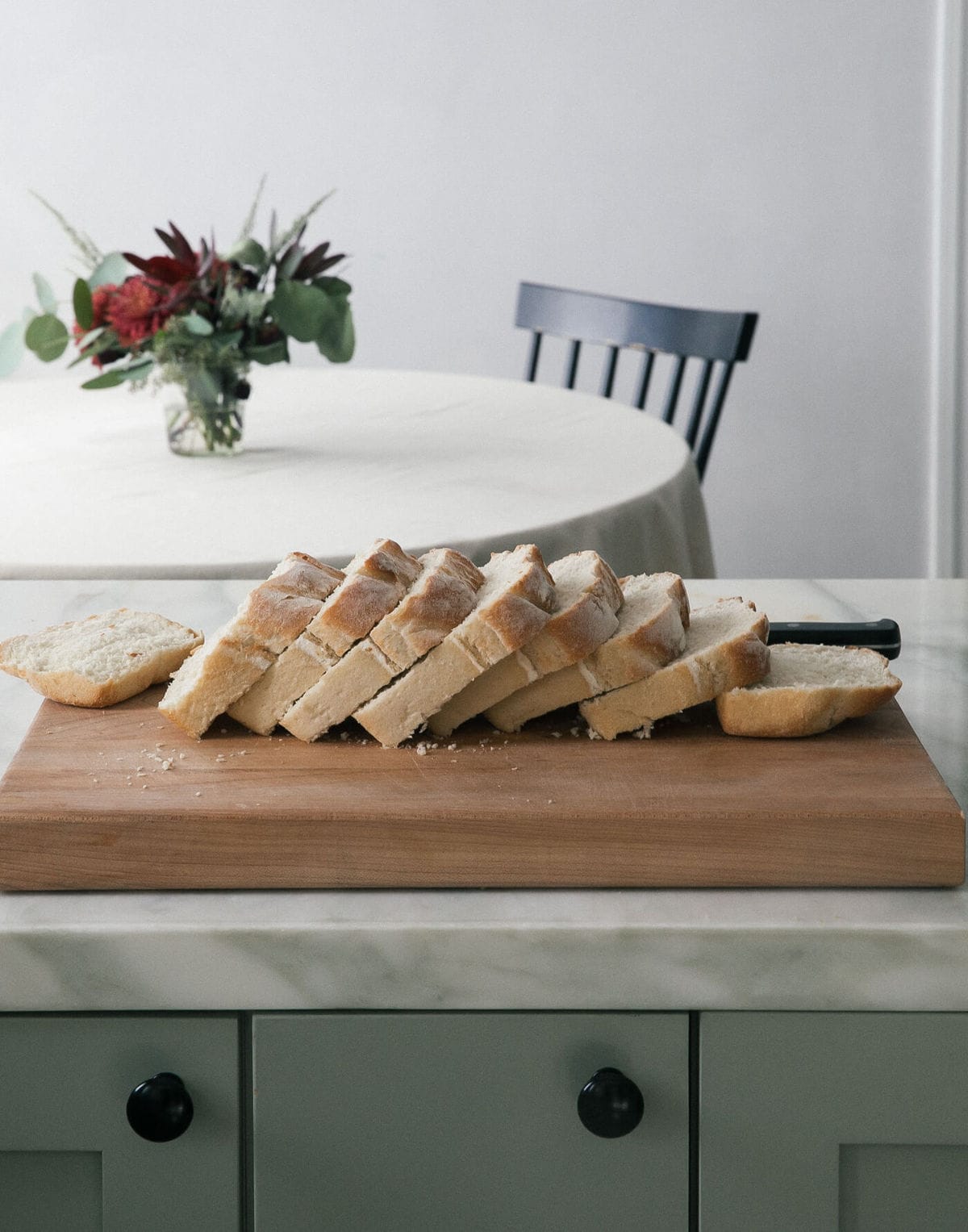 Slices of a French loaf on a cutting board. 