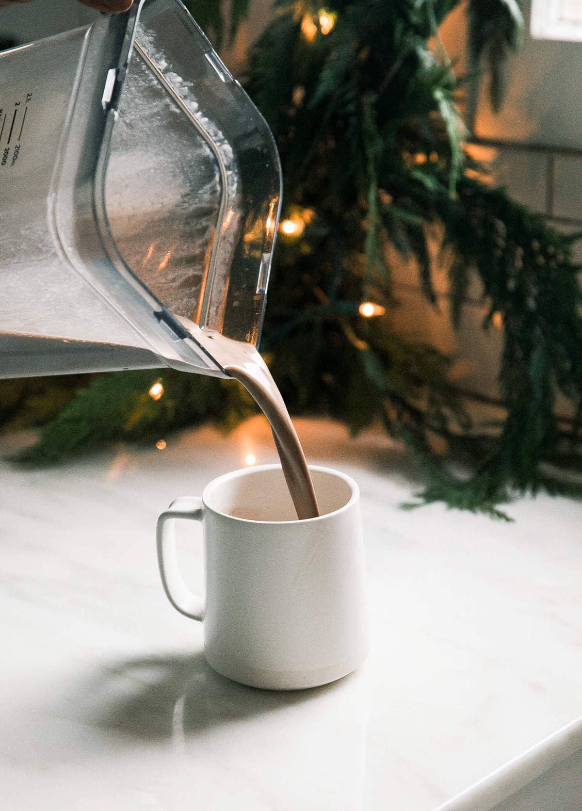 Oat Milk Hot Chocolate being poured into a mug. 