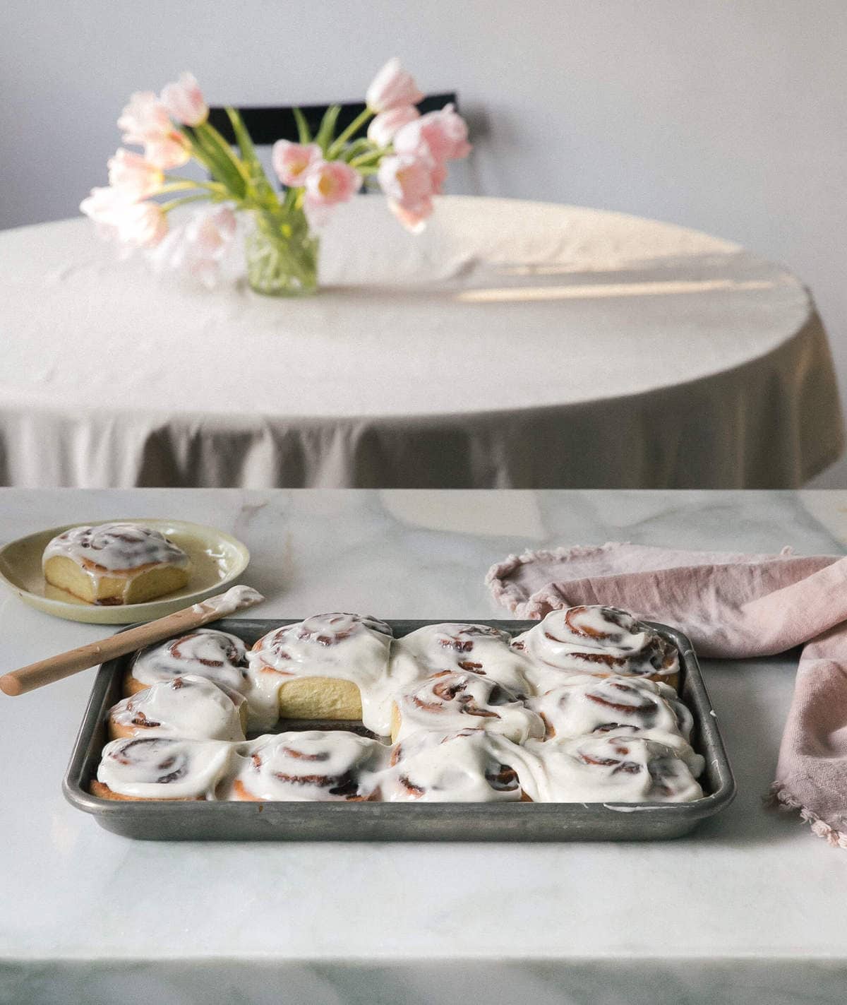 warm cinnamon rolls with frosting with center roll removed