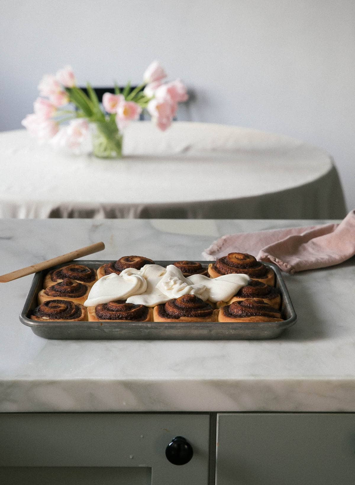 warm cinnamon rolls with frosting poured on top