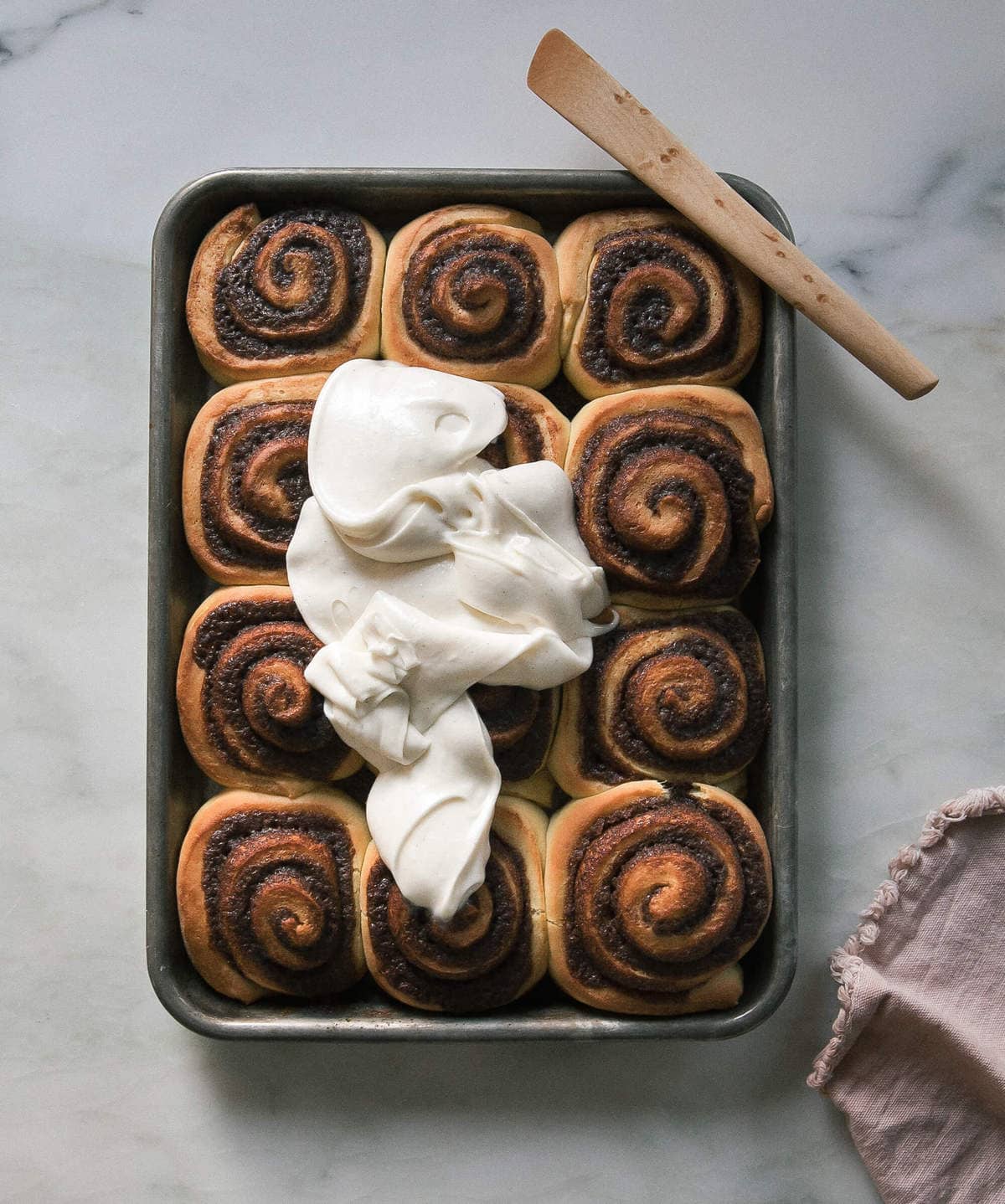 warm cinnamon rolls with frosting poured on top