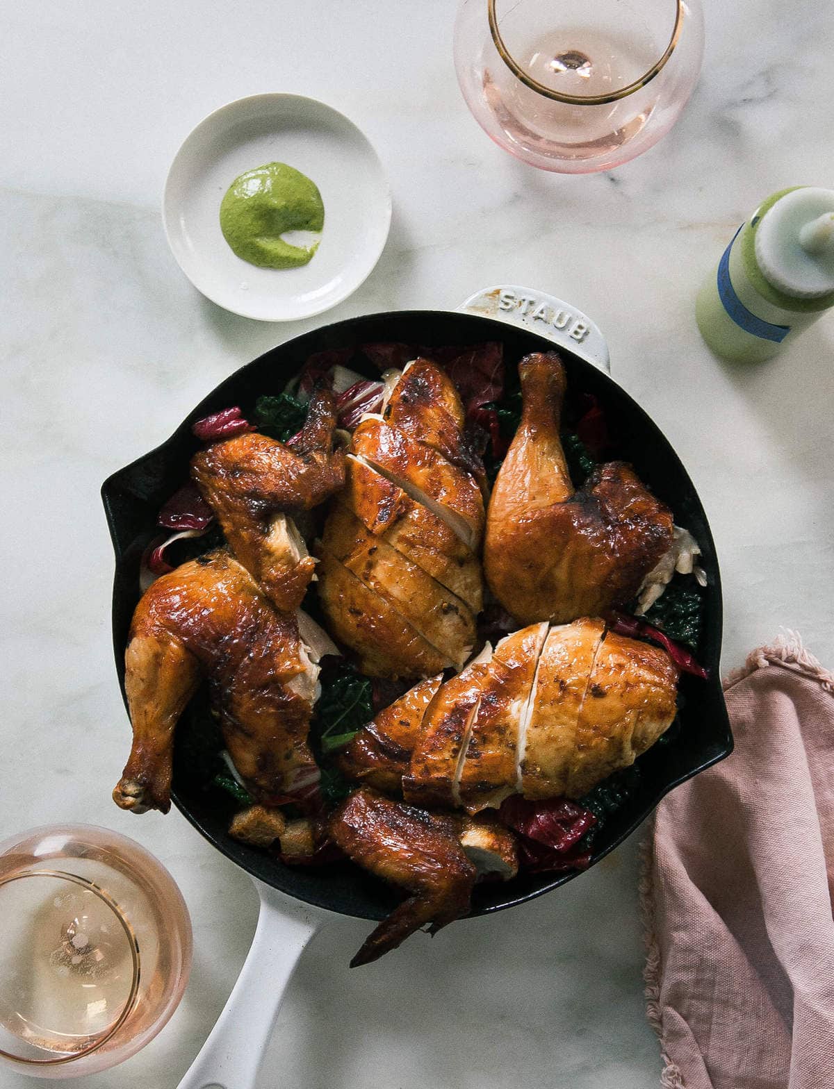 Pollo a la Brasa over a salad with aji verde. 