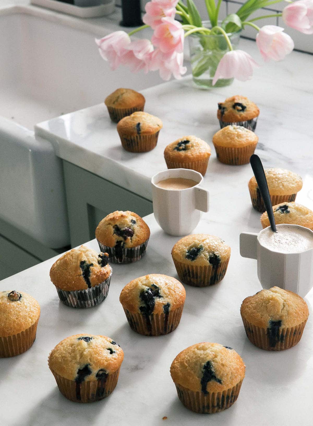 Best Blueberry Muffins on counter with tulips. 