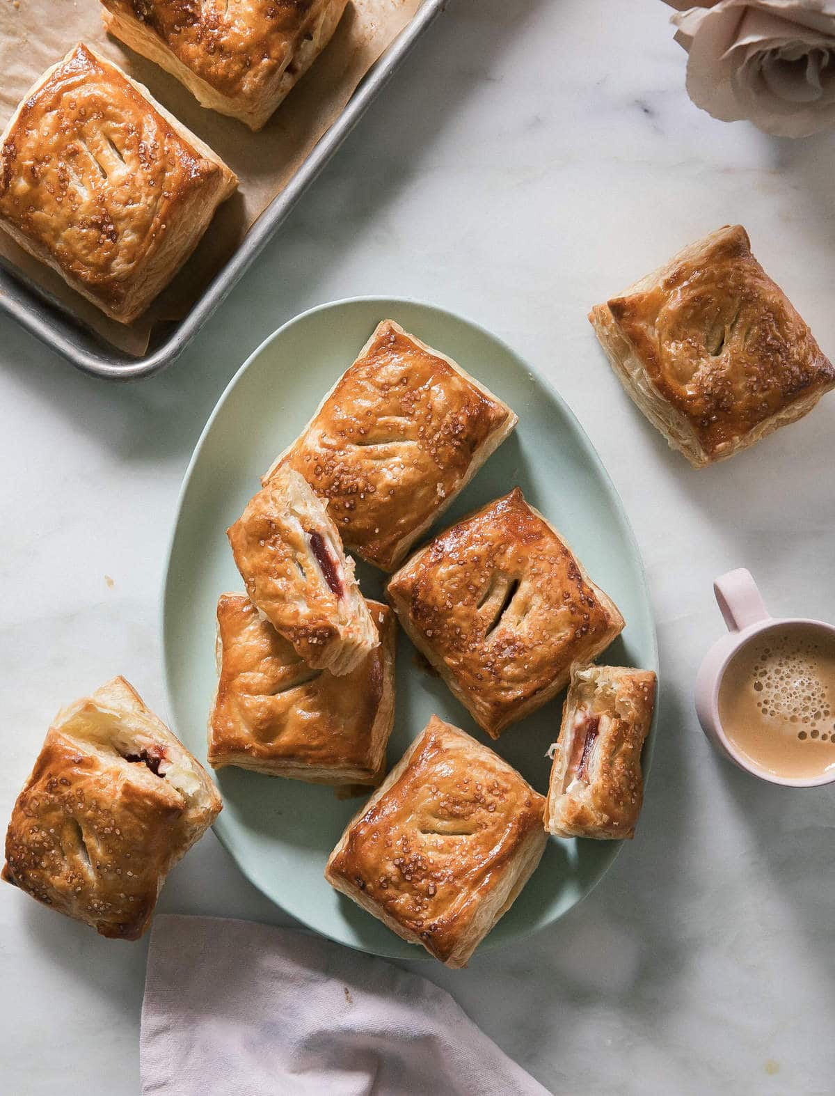 Pastelitos de Guayaba con Queso on a platter with coffee on the side. 