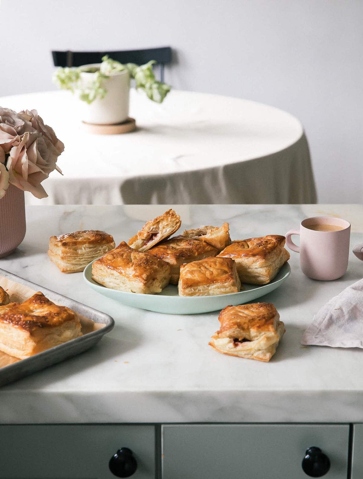 Pastelitos de Guayaba con Queso on a platter with coffee. 