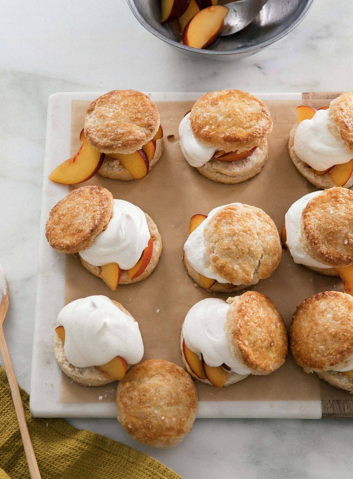 Peach Shortcakes assembled with peaches and whipped cream. 