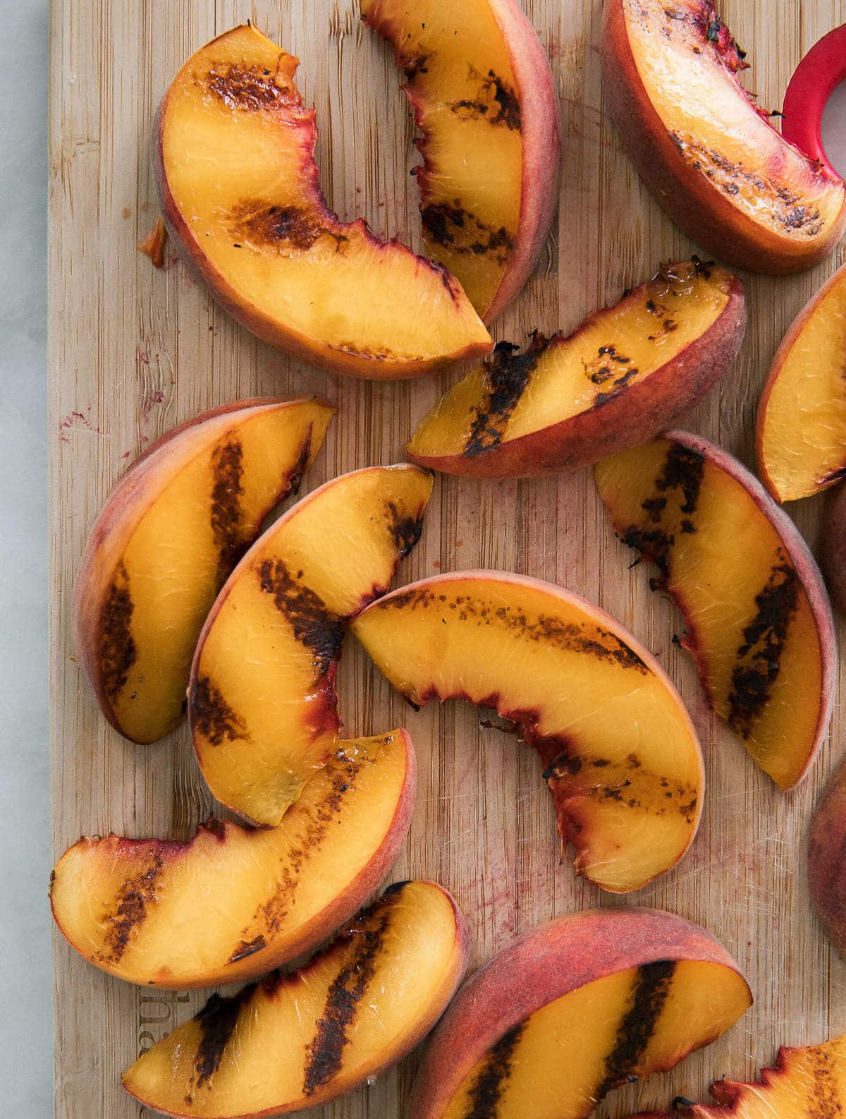 Grilled Peaches on a cutting board. 