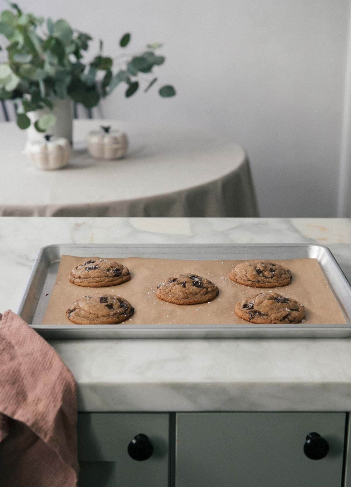 baked vegan chocolate chip cookies on a baking sheet