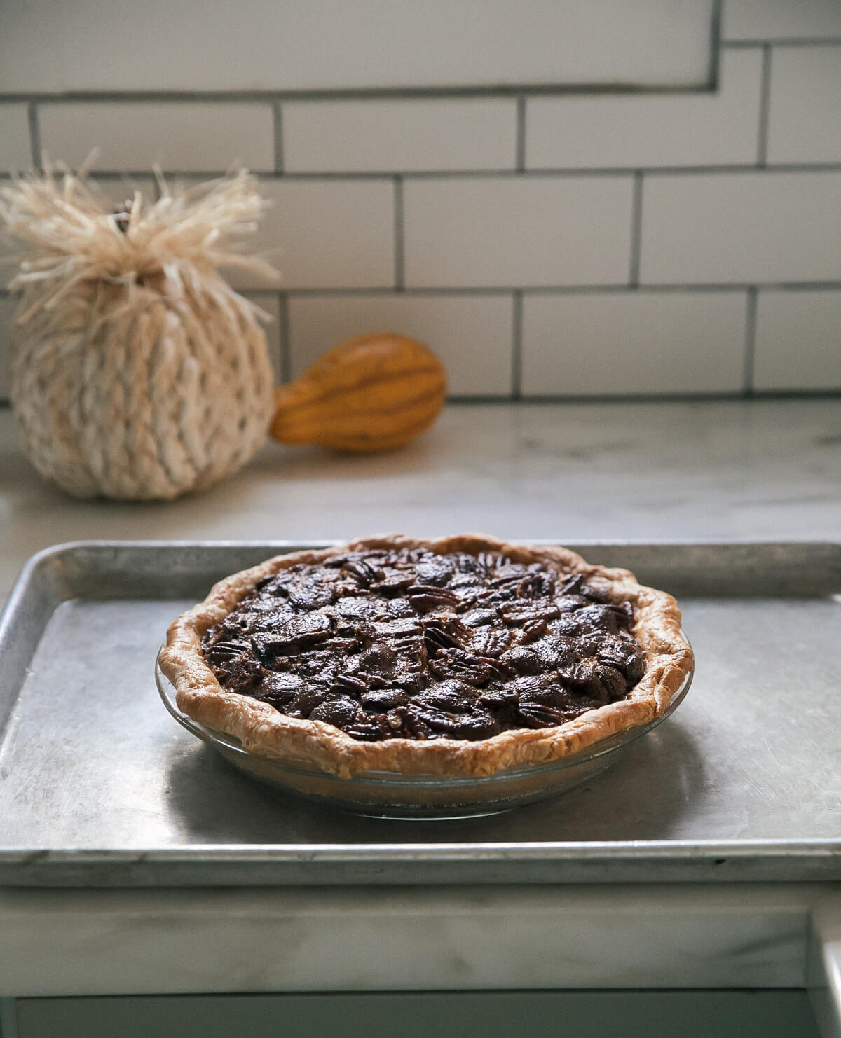 Dark Chocolate Pecan Pie on a baking sheet. 