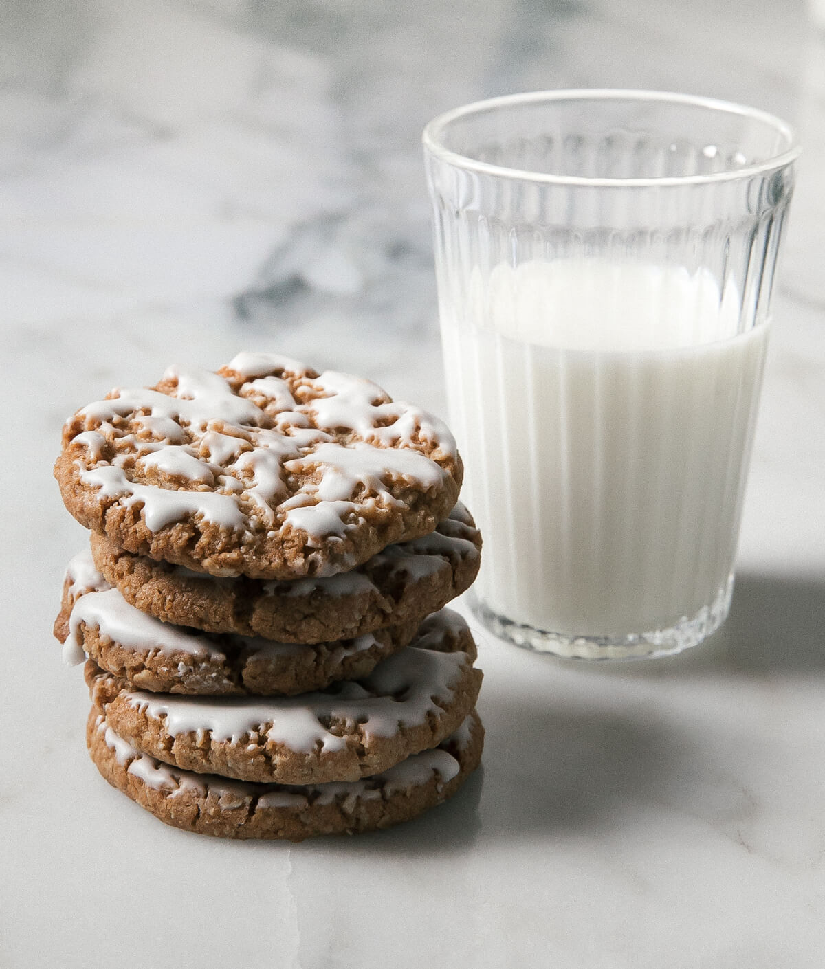 Iced Oatmeal Cookies with a glass of milk.