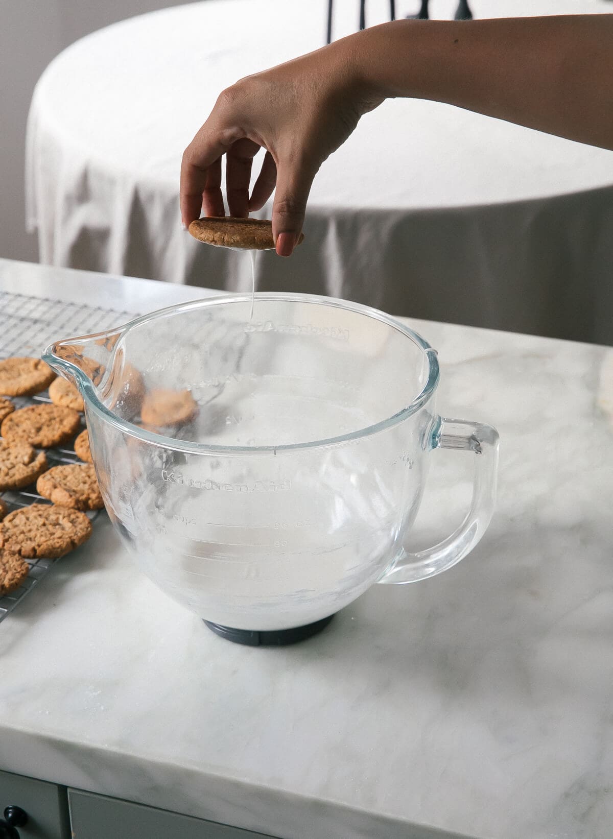 Dipping the cookies into the icing. 