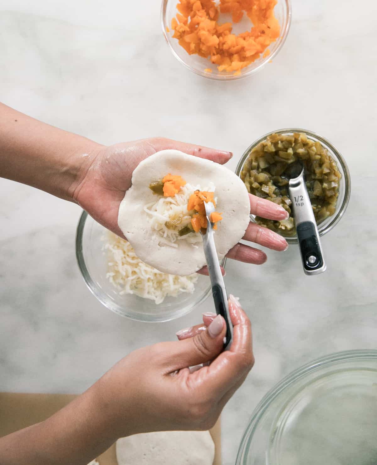 Pupusas being formed by hands