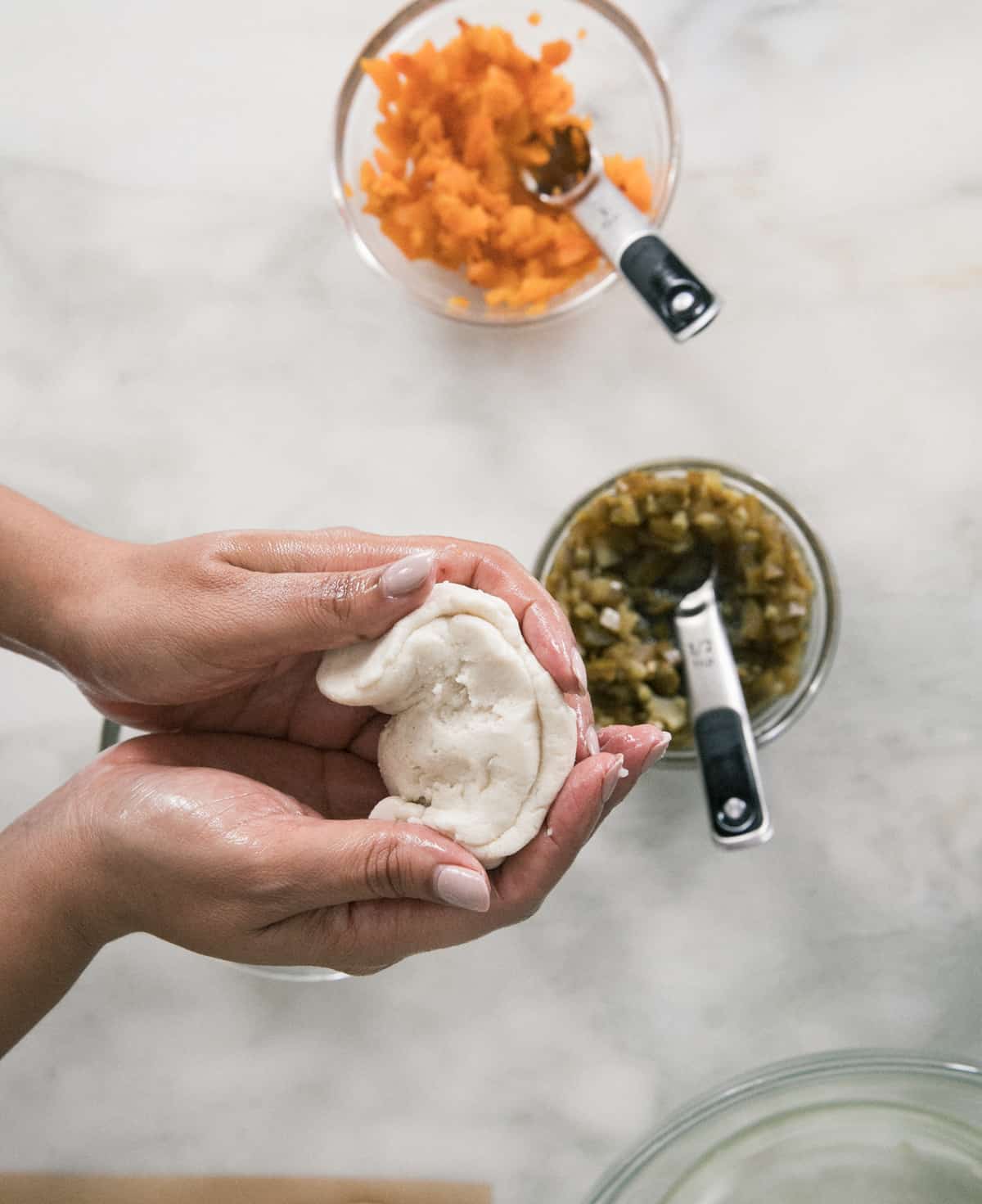 Pupusas being formed by hands