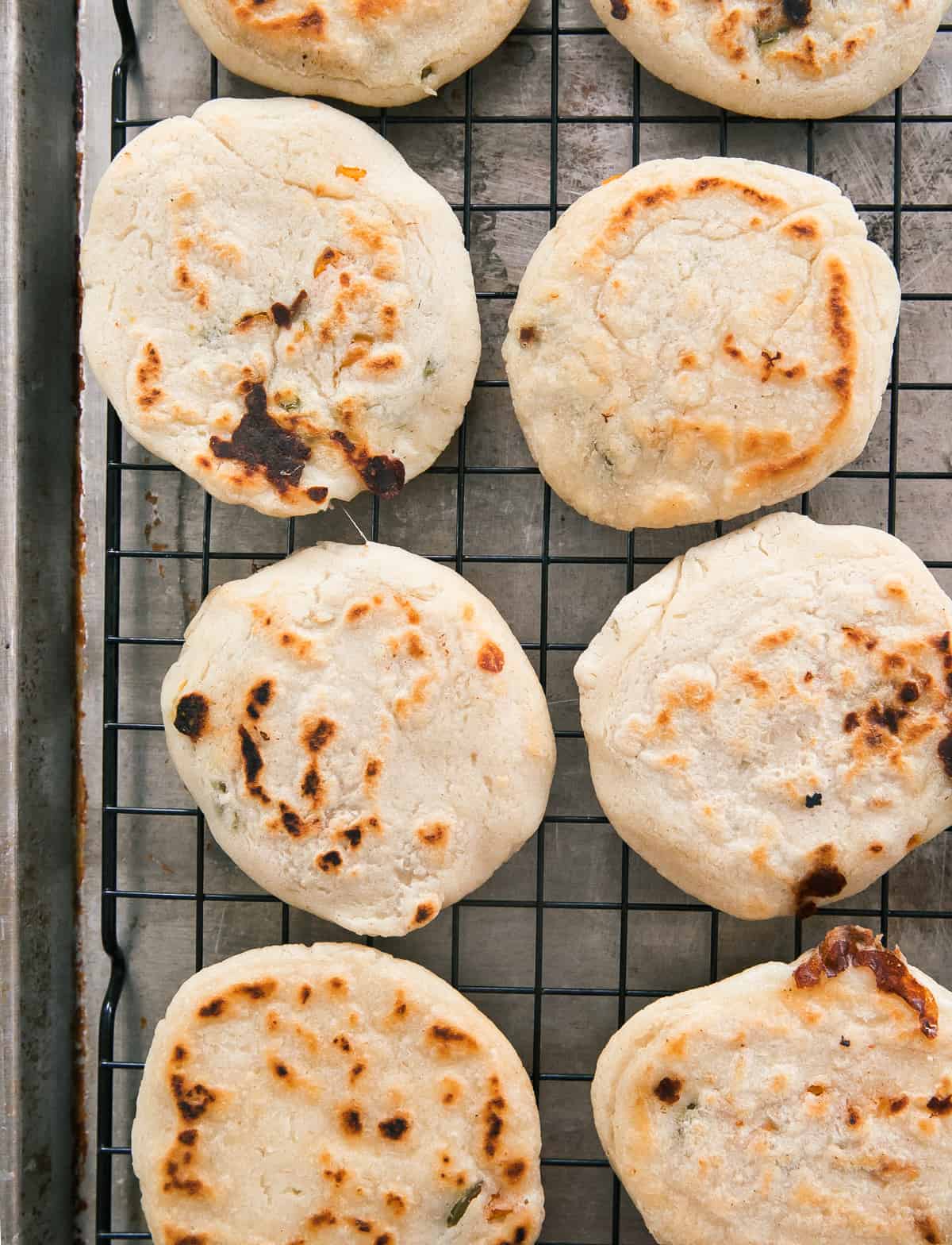 Warm pupusas on a baking sheet