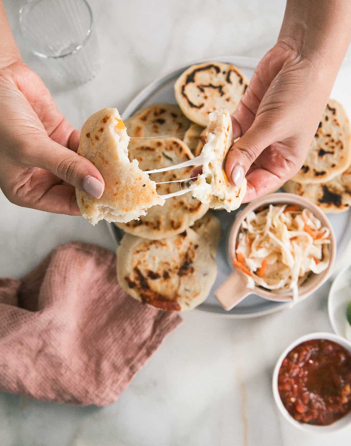 Pupusa being torn apart with cheese pull