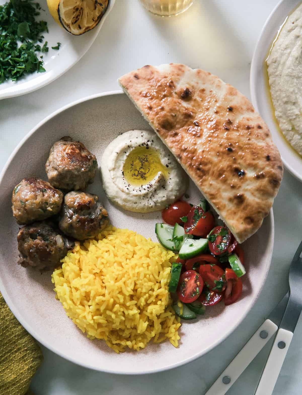 Lamb kofta bowl with rice, hummus and pita.