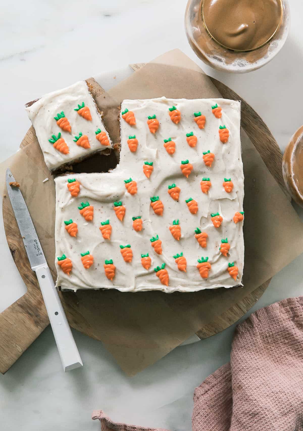 Mini Carrot Cake with Brown Butter Cream Cheese Frosting on a round board with a knife. 